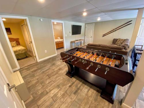a room with a pool table in the middle of a room at O7 Slopeside Bretton Woods Resort cottage with upscale stylings cozy decor tons of space in Carroll