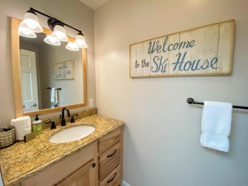 a bathroom with a sink and a mirror at O7 Slopeside Bretton Woods Resort cottage with upscale stylings cozy decor tons of space in Carroll