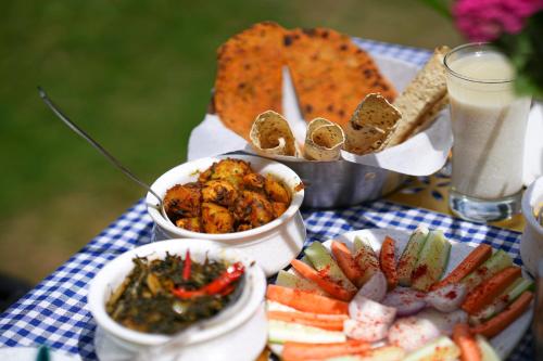 a table topped with different types of food and drinks at Chirping Hills Resort,Bhimtal in Bhīm Tāl