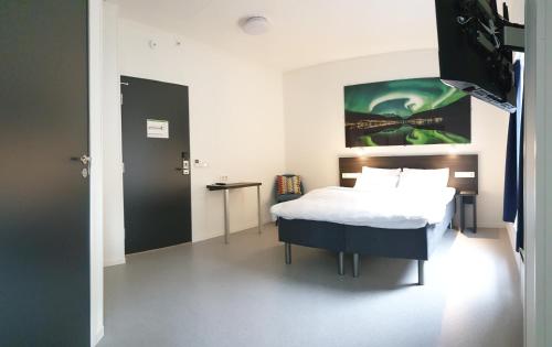 a bedroom with a bed and a television in it at Aiden by Best Western Harstad Narvik Airport in Harstad