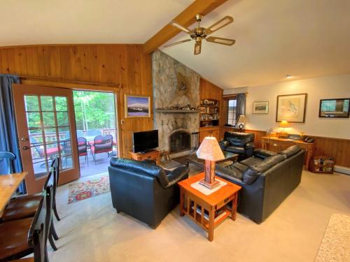 a living room with a couch and a fireplace at O9 NEW Renovated Bretton Woods slopeside condo with 2 living rooms foosball air hockey in Carroll
