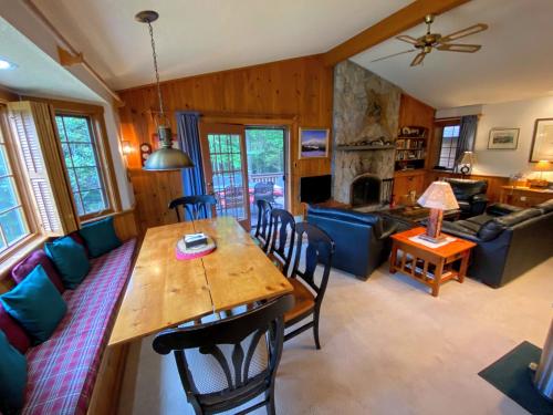 a dining room and living room with a table and chairs at O9 NEW Renovated Bretton Woods slopeside condo with 2 living rooms foosball air hockey in Carroll