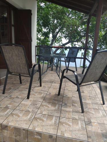 a group of chairs and a table on a patio at Villa Annoula in Pouríon