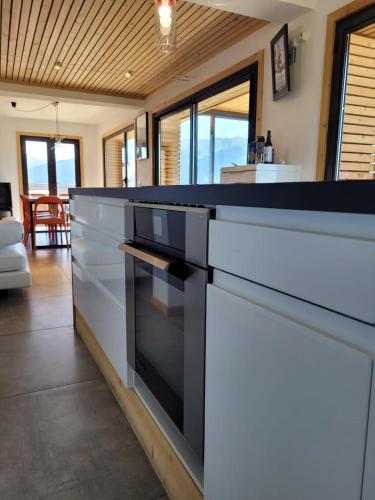 une cuisine avec un comptoir noir et blanc dans l'établissement Chalet Spa Fora Pista, à Bolquère-Pyrénées 2000