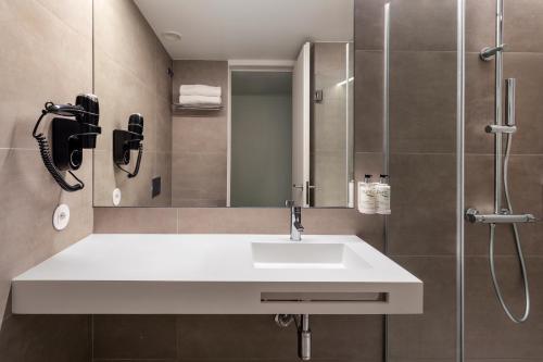 a bathroom with a sink and a shower at B&B HOTEL Famalicão in Vila Nova de Famalicão