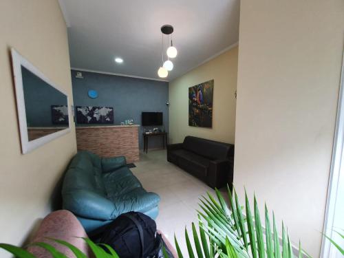 a living room with a couch and a chair at Hotel Jin Ju in Arujá