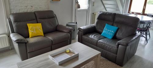 two leather chairs and a coffee table in a living room at Chez Stéphane in Rochefort