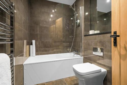 a bathroom with a white toilet and a shower at The Duke on The Test in Romsey