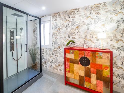 a bathroom with a shower and a red cabinet at Cubo's Boutique Urban Deluxe in Alhaurín el Grande