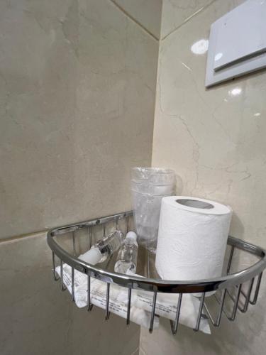 a toilet paper holder with a roll of toilet paper at Abrigo and Restaurant Portinho in Vila Praia de Âncora