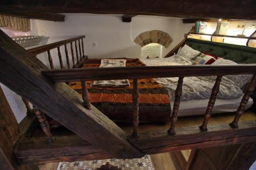 a bedroom with a wooden bed in a room at Medieval Super Studio in Vilnius