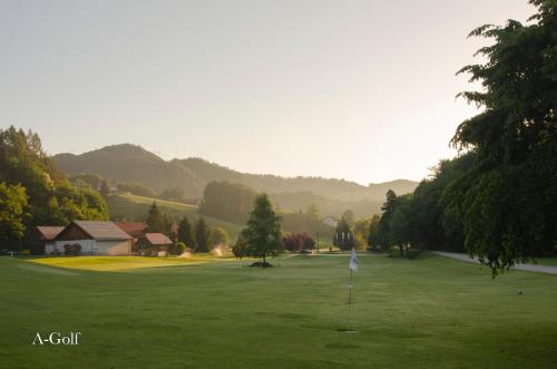 a golf course with a hole in the middle of a green at Apartments with Private Saunas & WELLNESS Gobi in Podčetrtek
