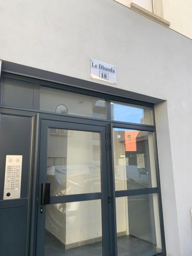 a door to a building with a sign above it at LE 18 Dhuoda in Nîmes