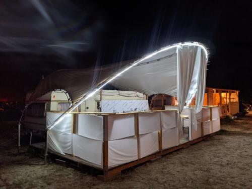 a boat is sitting on a trailer at night at SEA CARAVAN ON THE BEACH in Kiten