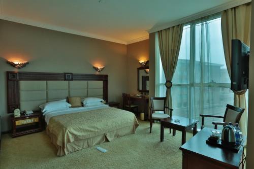 a hotel room with a bed and a television at Friendship International Hotel in Addis Ababa