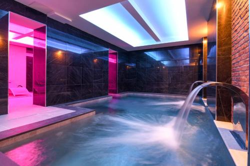 a bathroom with a hot tub with a water fountain at Hotel Master in Brescia