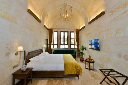 A bed or beds in a room at Evanthia Cave Suites