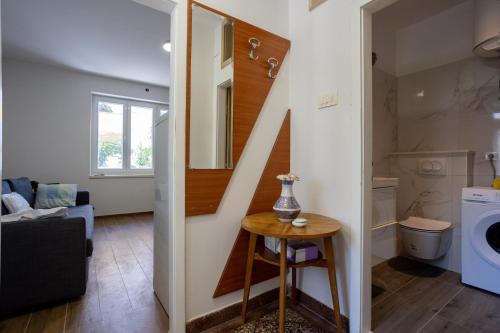 a living room with a staircase leading to a laundry room at Mediterranean Garden Apartements in Krilo
