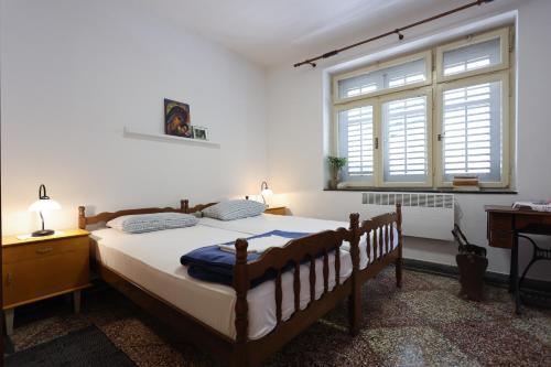 sypialnia z dużym łóżkiem i oknem w obiekcie Mediterranean Garden Apartements w mieście Krilo