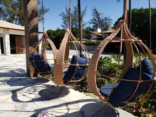 a swing set with blue seats on a playground at Deck de Búzios in Búzios