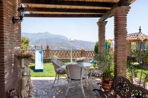 a patio with chairs and a table with a view at Villa privada para familias in Torrox