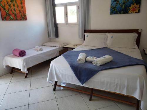 a bedroom with two beds with towels on them at Deck de Búzios in Búzios