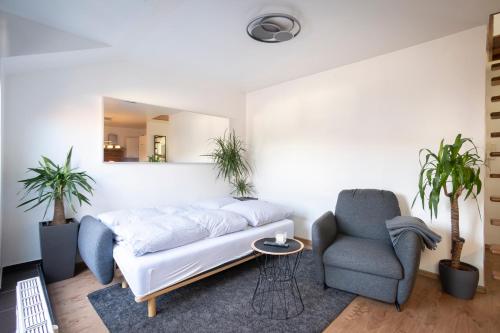 ハノーファーにあるStylish 2 Room Maisonette Hannover - Contactless Check-Inのソファと椅子のあるリビングルーム