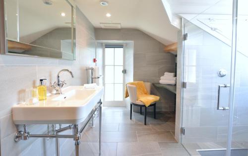 a bathroom with a sink and a shower at Fairfield House and Gardens in Bowness-on-Windermere