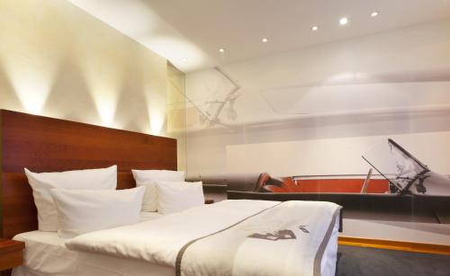 a bedroom with a large bed and a piano at Hotel Adler Asperg in Asperg
