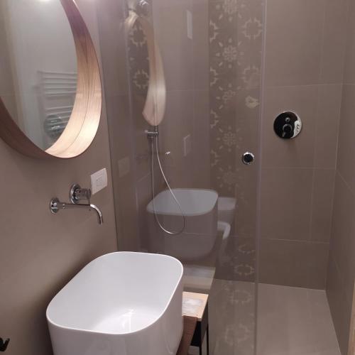 a bathroom with a toilet and a shower with a mirror at Apartments for you 2 in Matera
