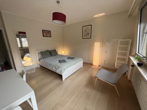 a bedroom with a bed and a desk and a chair at rooms train station in Luxembourg
