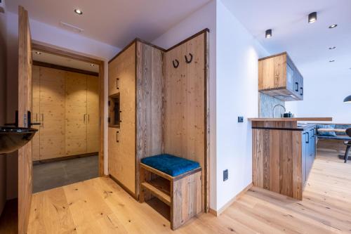 a room with wooden doors and a bench in a kitchen at Ladinser Hof Sternenhimmel in Castelrotto