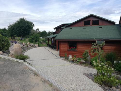 a log cabin with a path next to a building at Penzión u Coľa in Prievidza