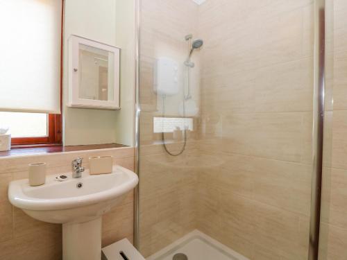 a bathroom with a shower and a sink at 48 Edenbank Road in Cupar