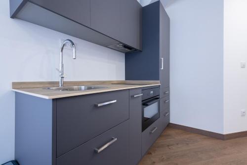 a kitchen with a sink and a stove at Casa de Miranda in Ézaro