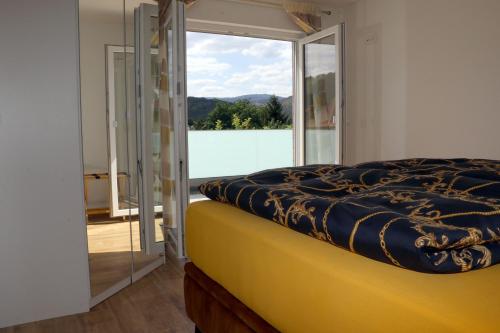 - une chambre avec un lit et une grande fenêtre dans l'établissement Ferienhaus Sonnenschein, à Wernigerode