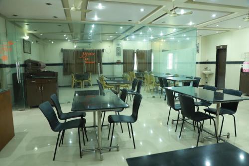 a group of tables and chairs in a room at HOTEL SAI PASO in Shirdi
