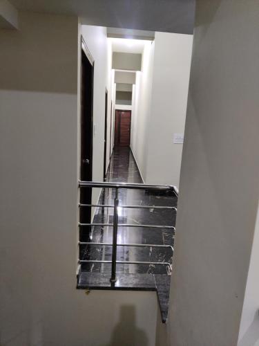 a stairwell in a building with a stair case at BILVA COMFORTS in Madhugiri