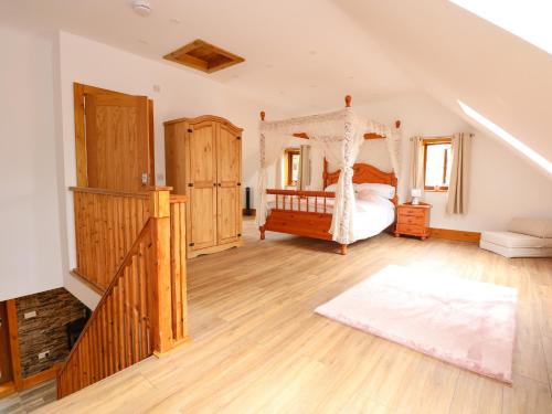 a bedroom with a bed with a canopy at Little Lodge in Kings Lynn