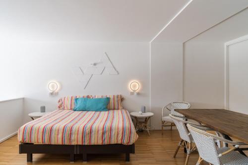 a bedroom with a bed and a wooden table at Porto Insight Apartment River View - Pool & Garage in Porto