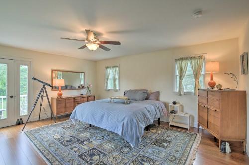 a bedroom with a bed and a ceiling fan at Spacious and Modern Ashley Falls Home on 1 Acre 