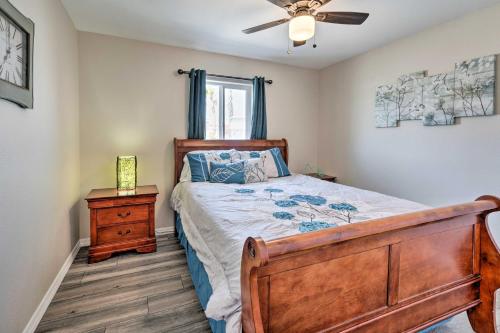 a bedroom with a bed and a ceiling fan at Pet-Friendly Bullhead City Abode with Game Room in Bullhead City