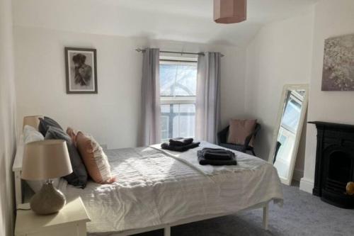 a bedroom with a bed and a window at Cosy 2 bed terraced house in Conwy in Conwy