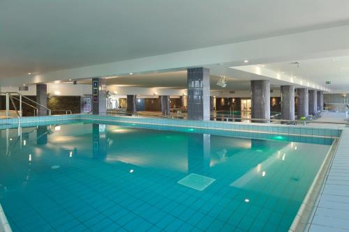 a large swimming pool in a building at Holiday Park Vile - Terme Krka in Strunjan