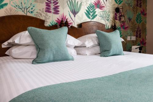 a large bed with two pillows on top of it at Sunbank House Metro Hotel in Perth