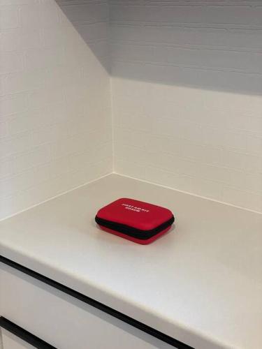 a red item sitting on top of a white table at Doublerainbow Resort Katsuura in Katsuura