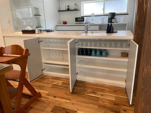 a kitchen with a sink and a counter with drinks at Doublerainbow Resort Katsuura in Katsuura