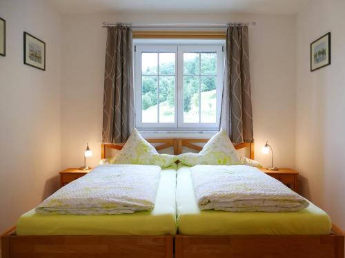 a bedroom with a large bed with a window at Ferienwohnung Schmidt in Aschau im Chiemgau