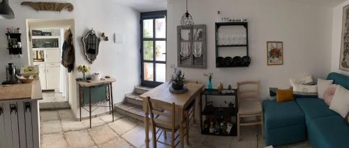 a living room with a blue couch and a table at THE SECRET GARDEN in Forza dʼAgro