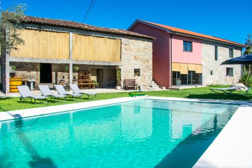 a swimming pool in front of a house at Casa Lima in Coucieiro